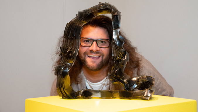 man looking through a glass artwork