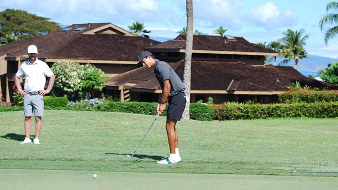 person chipping a golf ball