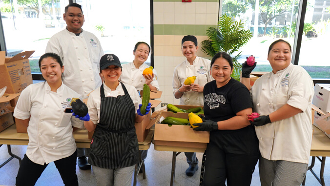 Students smiling with produce