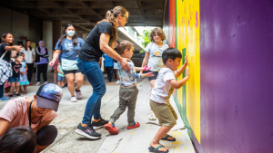 kids putting their handprint on a mural