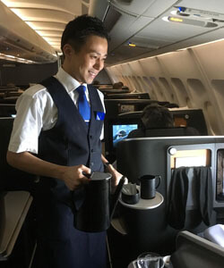 Kaz Shoji as a flight attendant