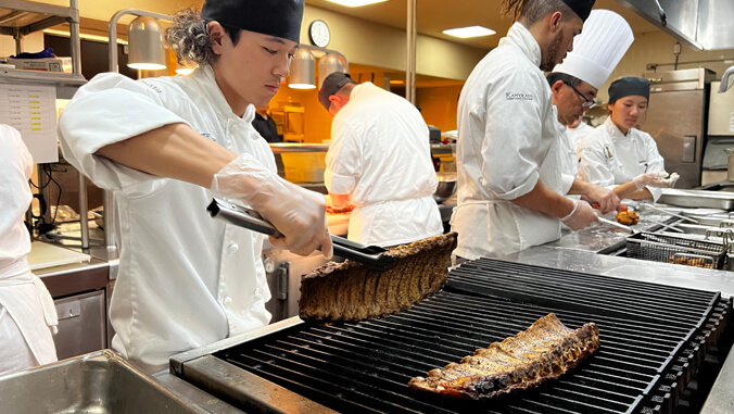 Students working on a grill