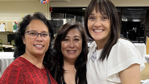 Three women smiling