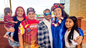 Smiling grad with family