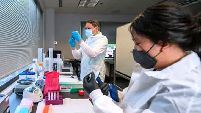 people working in a lab with lab coats