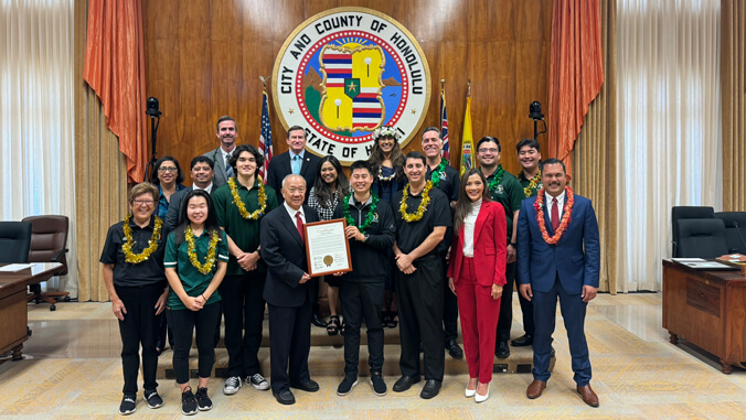 people standing holding a plaque