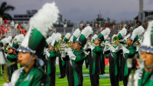 people in uniforms with instruments on a field