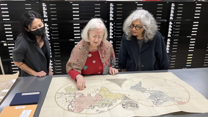 three women looking at a map