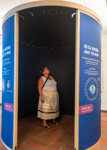 Woman looking up in an exhibit booth