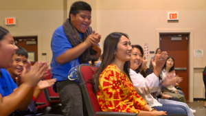 people cheering as one person smiles