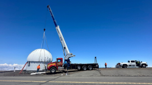 Crane moving the dome of Hoku Kea observatory