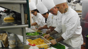 culinary students and instructors working with food