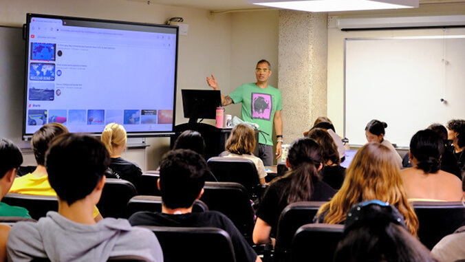 person lecturing to group of students