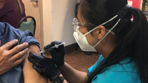 Nursing student administering an injection