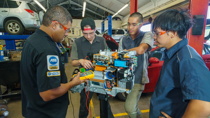 Students at work in a car repair shop