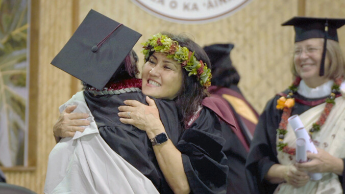 Woman hugs graduate