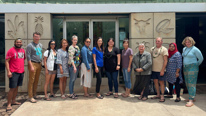 a group in front of the molokai education center.