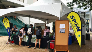 People at a booth outside campus center