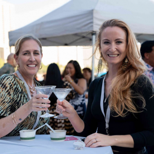 Two women raising martini glasses