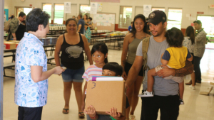 Family walking with their box of books