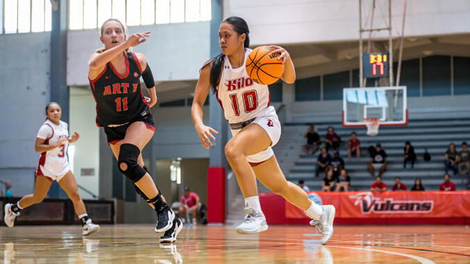 U H Hilo womens basketball player on court