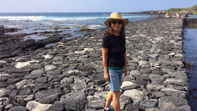 Person standing on the rocks of a fishpond