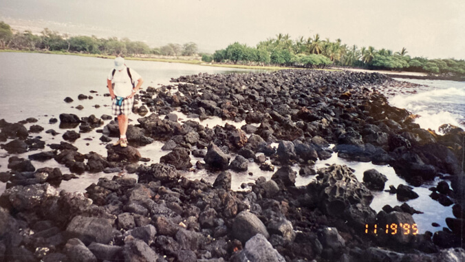 Person standing on the rocks of a fishpond