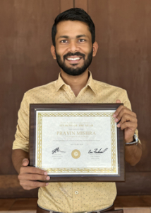 student holding award