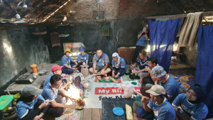 People seated on the floor of a room