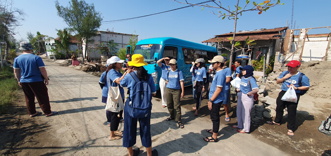 People standing on a road near a van