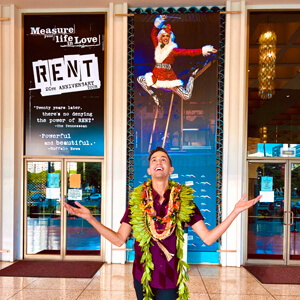 Tavares in front of RENT sign