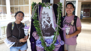 Two students with Lili uokalani's portrait