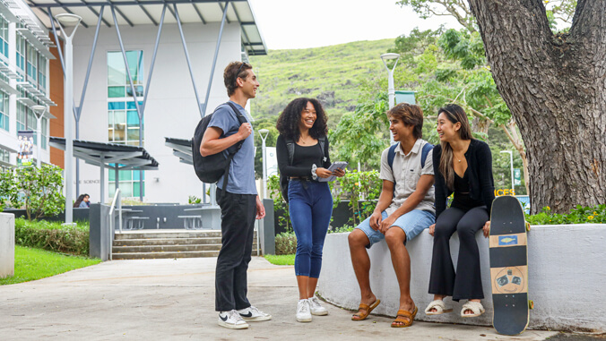 U H Manoa students sitting and standing