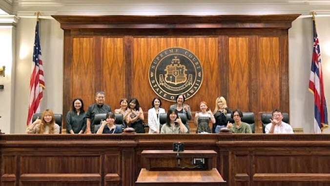 group of people behind court bench