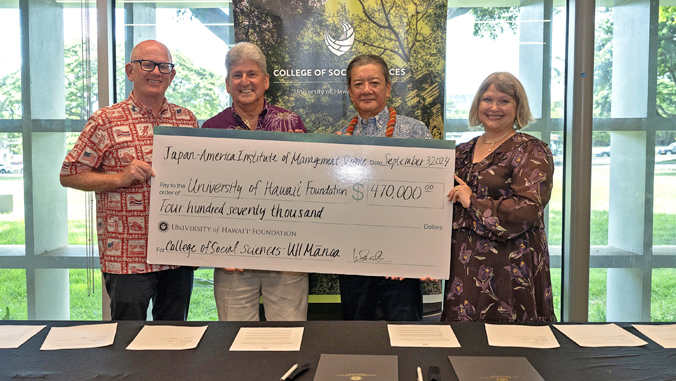 people standing holding a large check