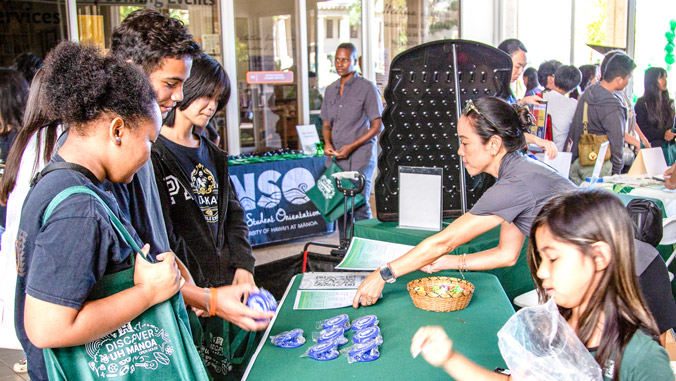 people looking at thing at a booth