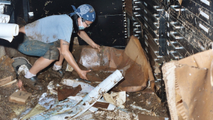 library staff helping salvage muddy maps