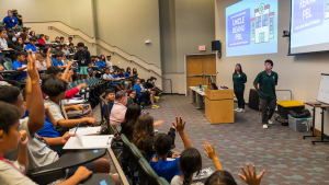 medical students take questions from the sixth graders.