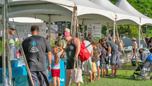 several tents lined up in a grass lawn