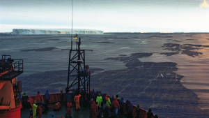 researchers on vessel looking at ocean