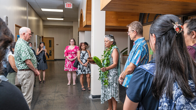 people gathering around and standing in a room