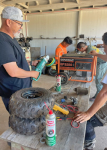 people working on tools and machinery