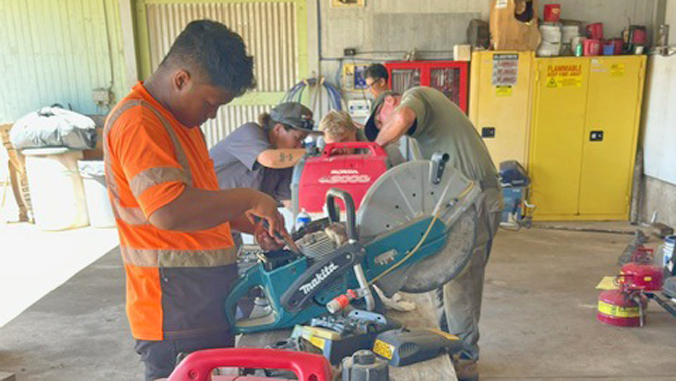 people working on tools and machinery