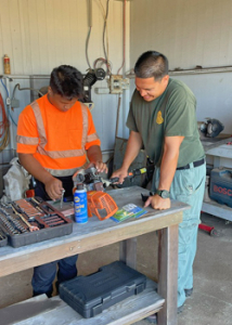 people working on tools and machinery