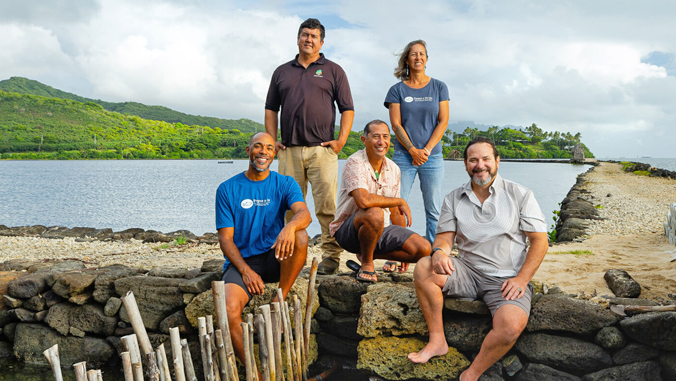 people in front of a large fishpond