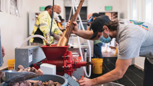 person working on a large mill machine