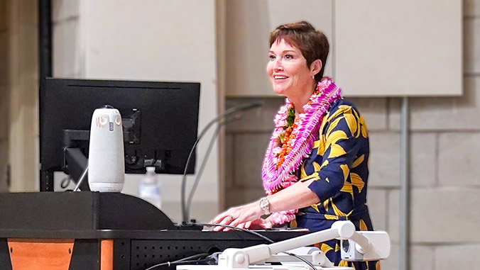 woman smiling at a podium