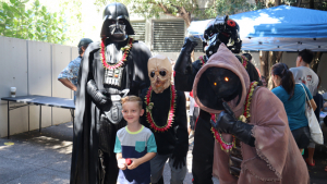 boy posing with people in costumes