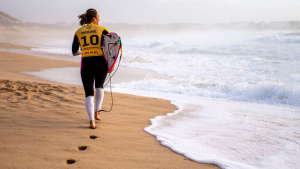 woman running with surfboard