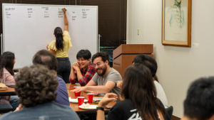 students discussing in front of a white board